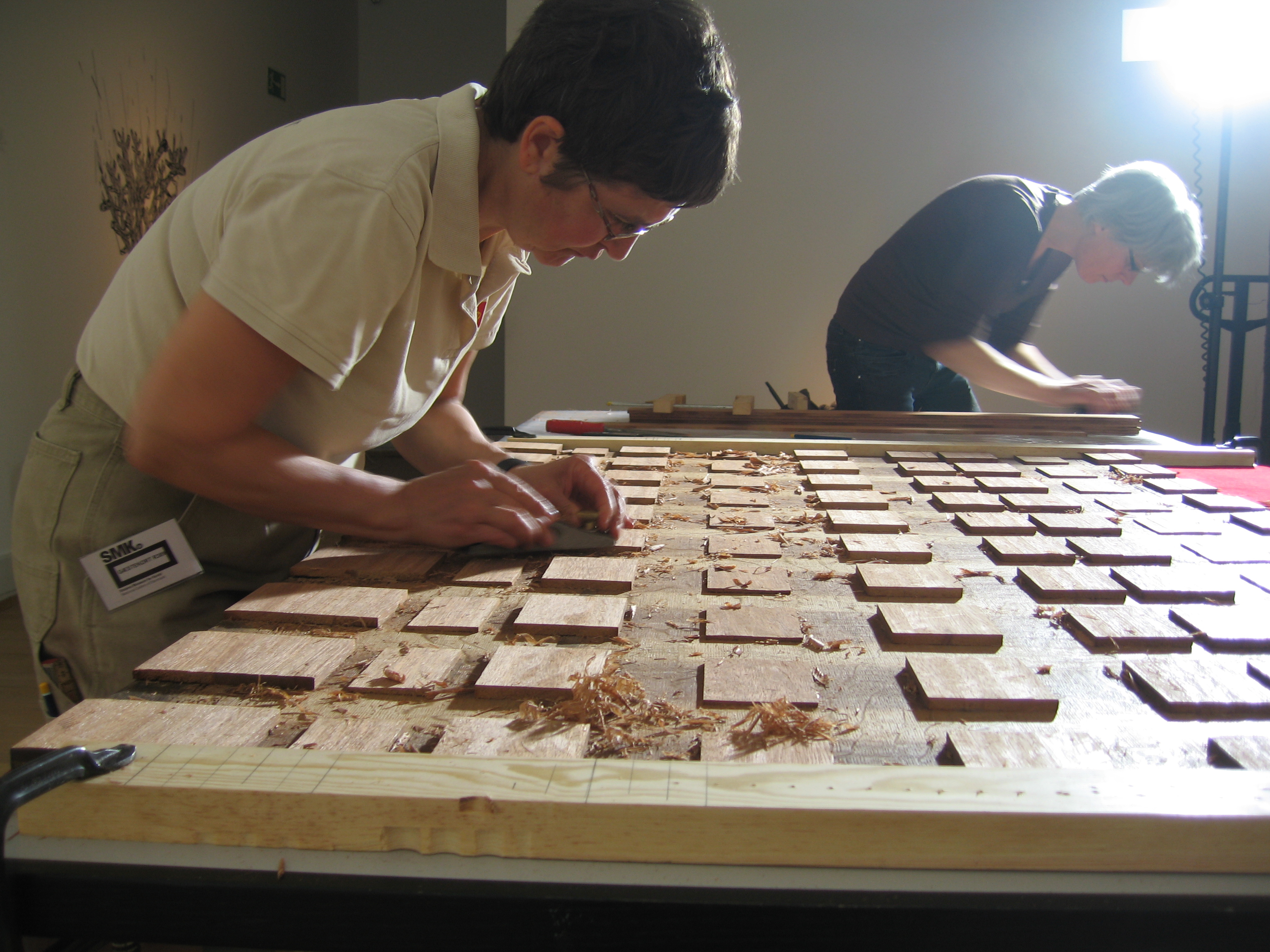 National Musuem conservators using hand tools to thin the old cradle